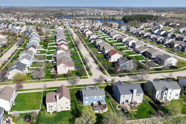 birds eye view of property with a water view and a residential view