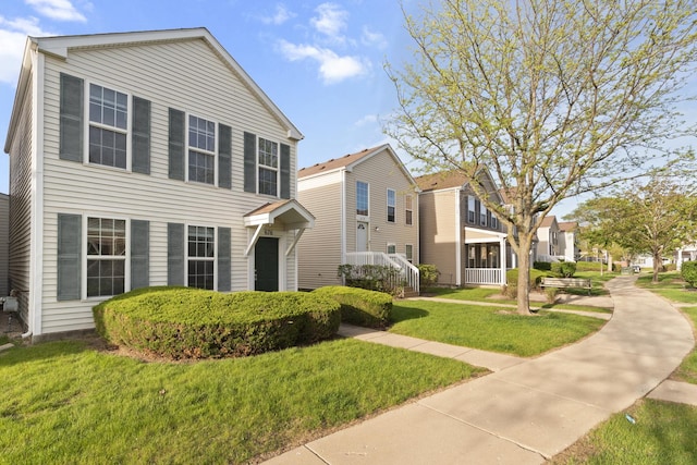 view of front facade with a residential view and a front lawn