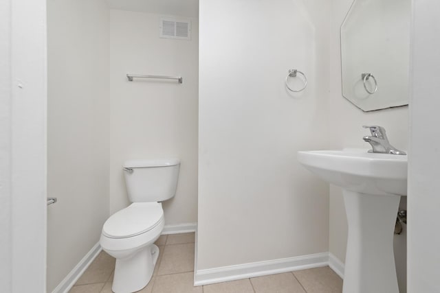bathroom with toilet, tile patterned floors, visible vents, and baseboards