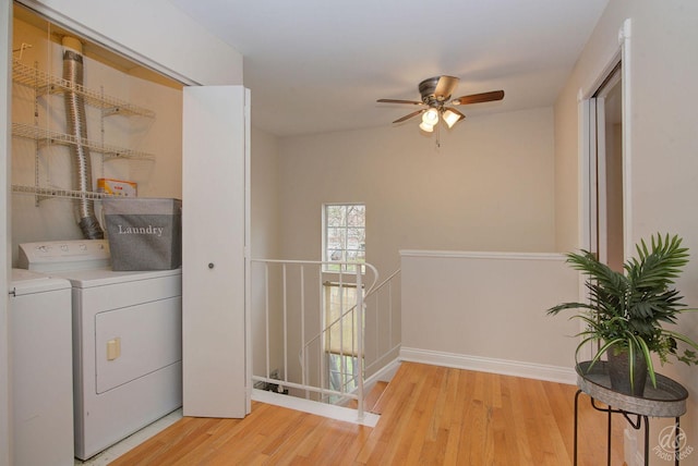 laundry area with laundry area, light wood-style floors, ceiling fan, and separate washer and dryer