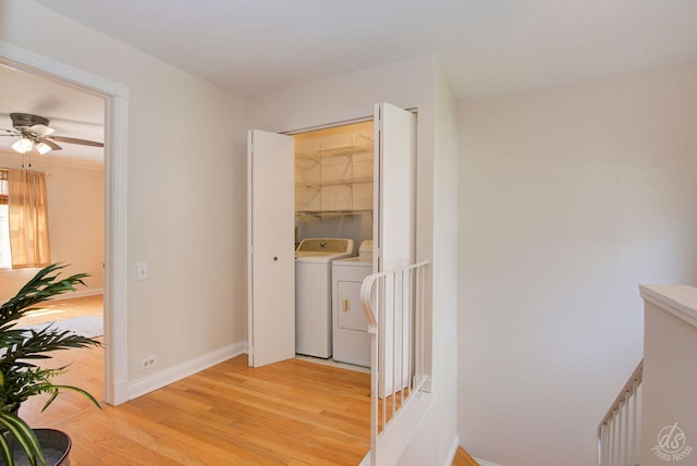 hall featuring baseboards, washing machine and dryer, and light wood-type flooring