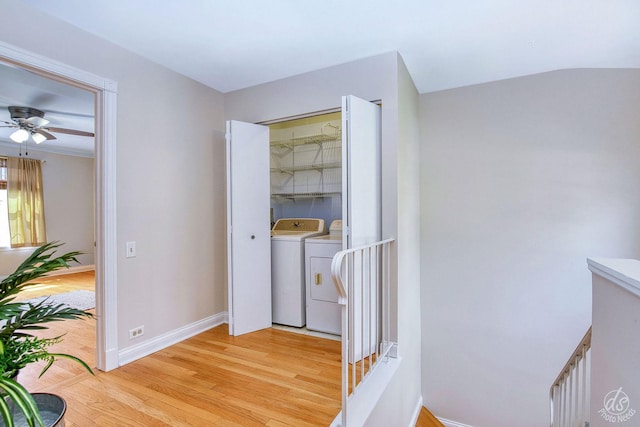 interior space featuring separate washer and dryer, baseboards, and light wood finished floors