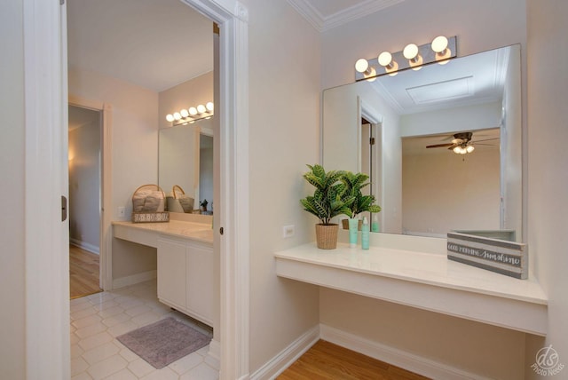 bathroom with crown molding, baseboards, tile patterned flooring, and vanity
