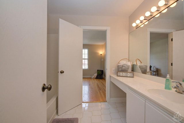 bathroom featuring vanity, baseboards, and tile patterned floors