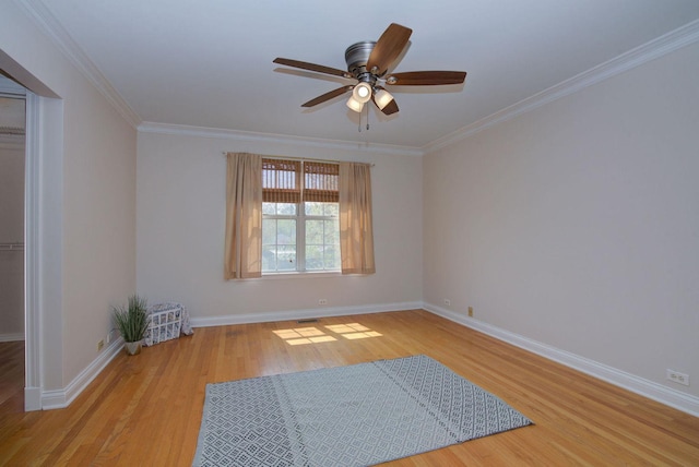 unfurnished room featuring crown molding, ceiling fan, baseboards, and wood finished floors