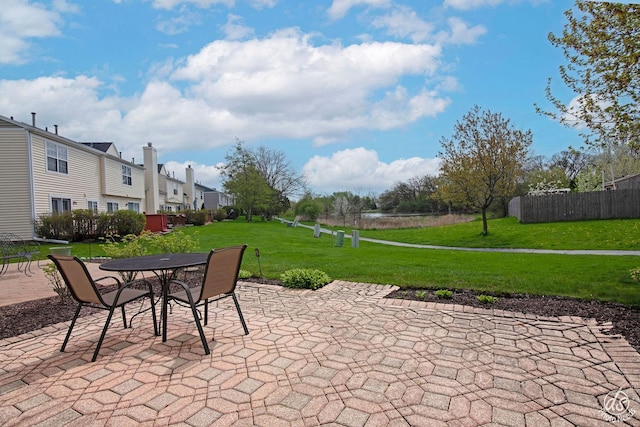 view of patio / terrace with fence, a residential view, and outdoor dining space