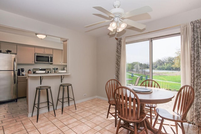 dining room featuring baseboards and ceiling fan