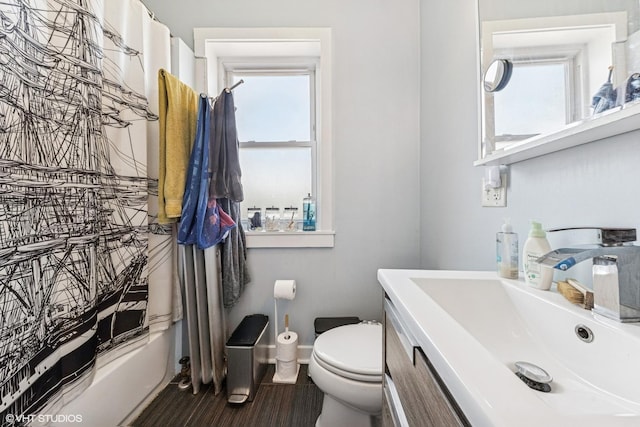 bathroom featuring vanity, baseboards, shower / bath combination with curtain, and toilet