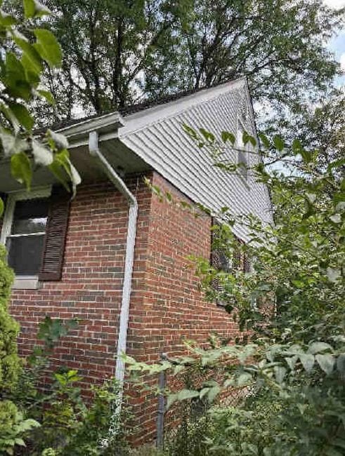 view of property exterior featuring brick siding