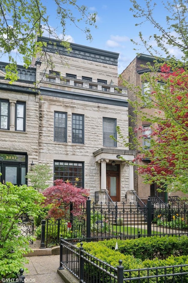 2535 N Burling St, Chicago, IL 60614 - view of front of home featuring a fenced front yard and stone siding