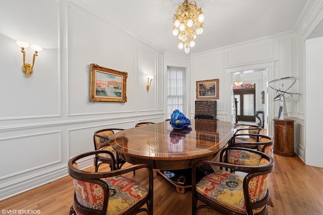2535 N Burling St, Chicago, IL 60614 - dining area with a decorative wall, light wood-type flooring, a chandelier, and ornamental molding