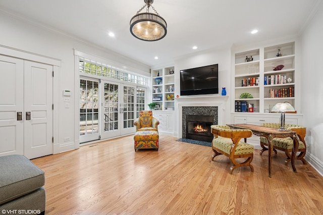 2535 N Burling St, Chicago, IL 60614 - sitting room with wood finished floors, ornamental molding, a fireplace with flush hearth, built in features, and baseboards
