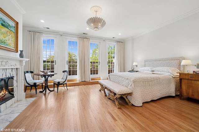 2535 N Burling St, Chicago, IL 60614 - bedroom with ornamental molding, a high end fireplace, light wood-style floors, access to exterior, and a chandelier