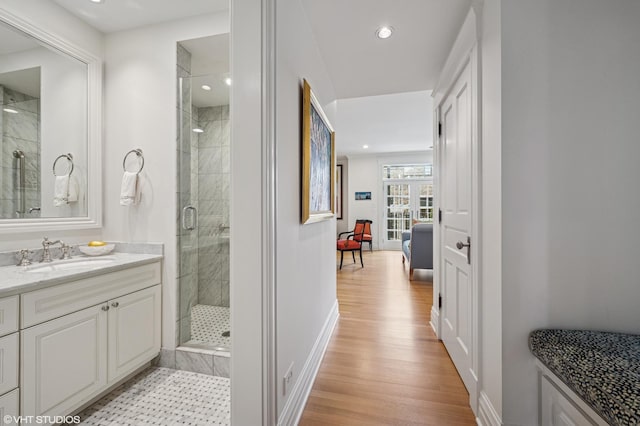 2535 N Burling St, Chicago, IL 60614 - bathroom with a shower stall, vanity, wood finished floors, baseboards, and recessed lighting