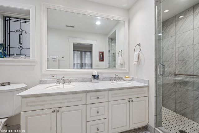 2535 N Burling St, Chicago, IL 60614 - bathroom featuring a shower stall, recessed lighting, double vanity, and toilet