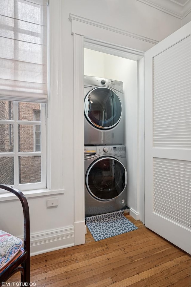2535 N Burling St, Chicago, IL 60614 - clothes washing area with stacked washer / dryer and wood finished floors