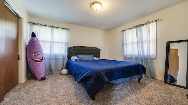 bedroom featuring carpet floors and baseboards