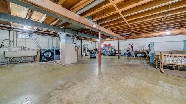 below grade area with a sink and washing machine and clothes dryer