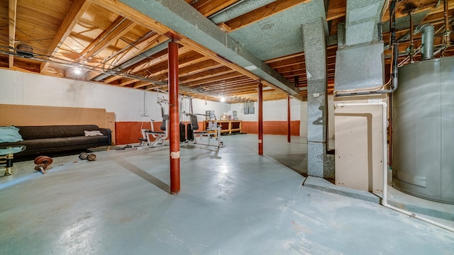 unfinished below grade area featuring water heater