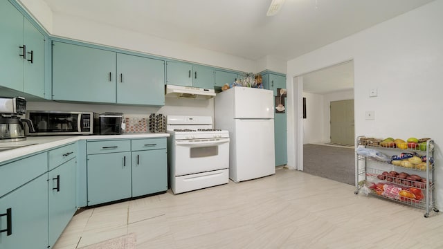 kitchen with light countertops, light floors, under cabinet range hood, and white appliances