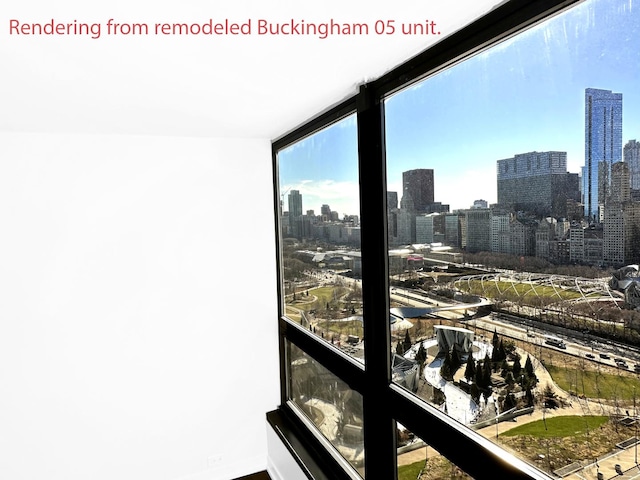 interior space featuring expansive windows, a city view, and baseboards