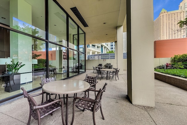 view of patio featuring fence and outdoor dining space