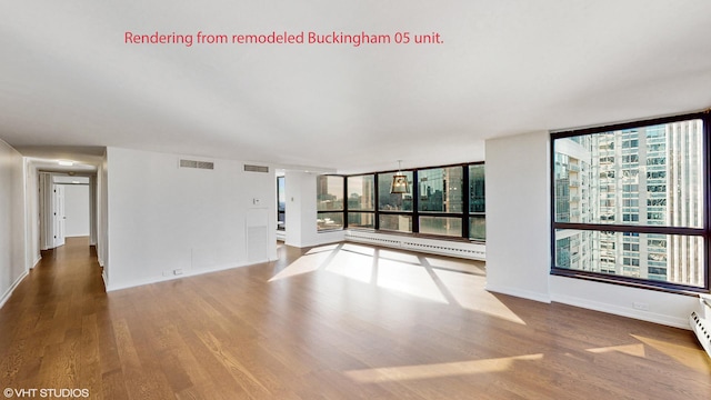 unfurnished living room with a healthy amount of sunlight, wood finished floors, and visible vents