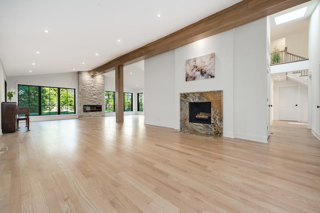 118 Lockerbie Ln, Wilmette, IL 60091 - unfurnished living room featuring a high end fireplace, high vaulted ceiling, recessed lighting, light wood-style floors, and baseboards
