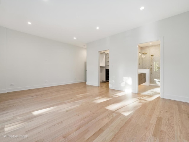 118 Lockerbie Ln, Wilmette, IL 60091 - unfurnished bedroom with baseboards, light wood-type flooring, recessed lighting, connected bathroom, and a walk in closet