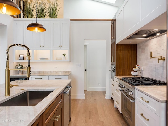 118 Lockerbie Ln, Wilmette, IL 60091 - kitchen featuring a sink, appliances with stainless steel finishes, light wood-type flooring, backsplash, and white cabinetry