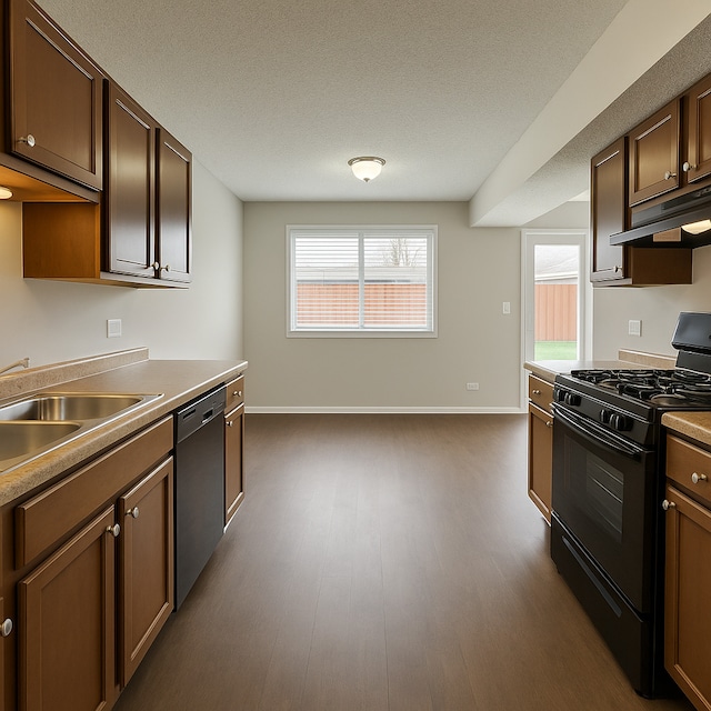 kitchen with black range with gas cooktop, dishwasher, a sink, baseboards, and under cabinet range hood