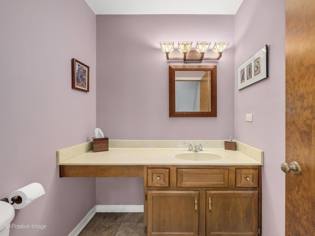 bathroom featuring toilet, tile patterned flooring, and vanity