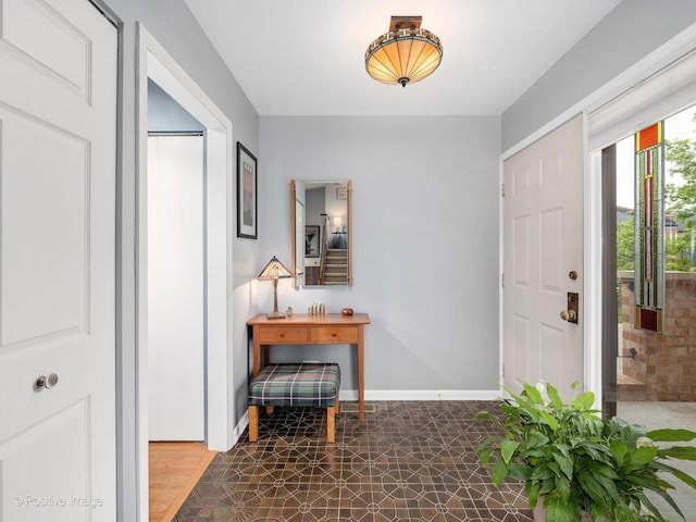 entryway featuring baseboards and tile patterned floors