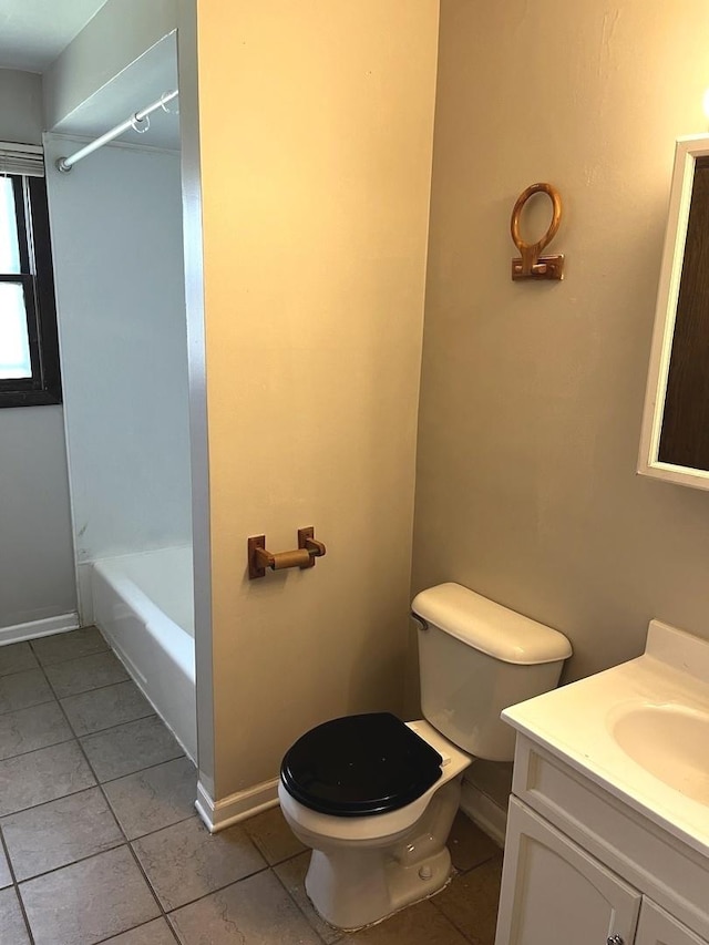 bathroom with vanity, toilet, baseboards, shower / bathing tub combination, and tile patterned floors