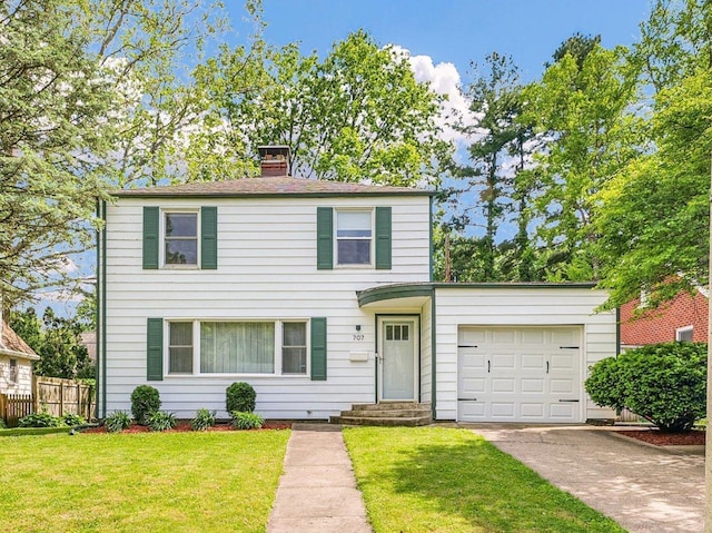 707 W Vermont Ave, Urbana, IL 61801 - view of front of home with a garage, driveway, and a chimney