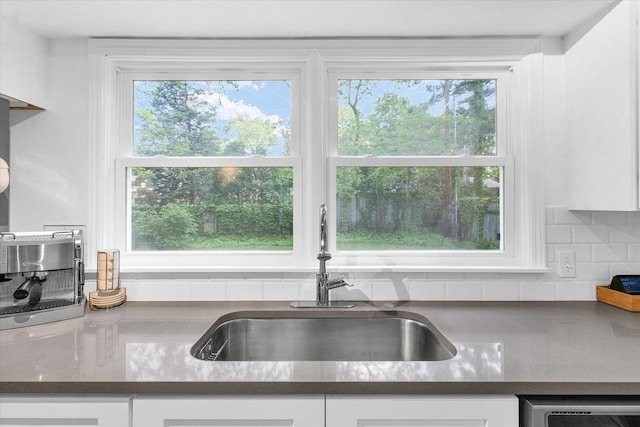 707 W Vermont Ave, Urbana, IL 61801 - kitchen with a sink, white cabinetry, backsplash, and dishwashing machine