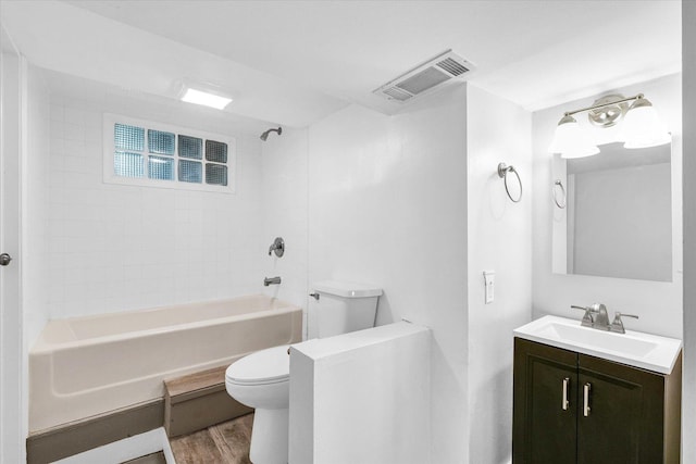 707 W Vermont Ave, Urbana, IL 61801 - bathroom featuring toilet, wood finished floors, shower / washtub combination, and vanity