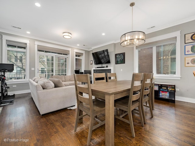 dining area with crown molding, baseboards, a chandelier, dark wood-type flooring, and recessed lighting
