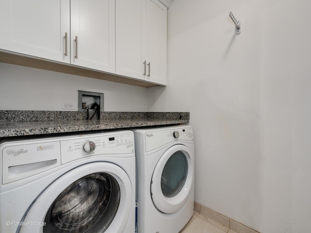 laundry room with washer and dryer, light tile patterned floors, cabinet space, and baseboards