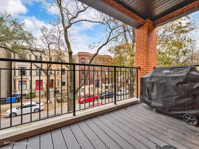 wooden deck with a grill