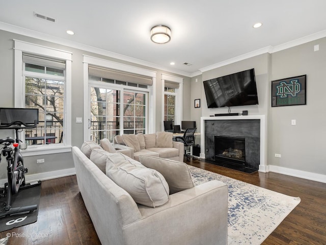 living room with crown molding, dark wood finished floors, baseboards, recessed lighting, and a fireplace