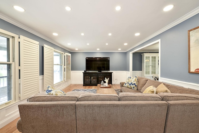living room with recessed lighting, wainscoting, ornamental molding, and light wood-style floors