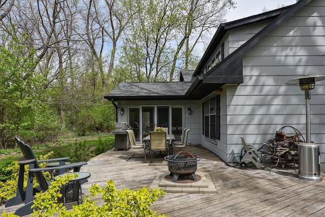 deck featuring an outdoor fire pit, area for grilling, and outdoor dining space