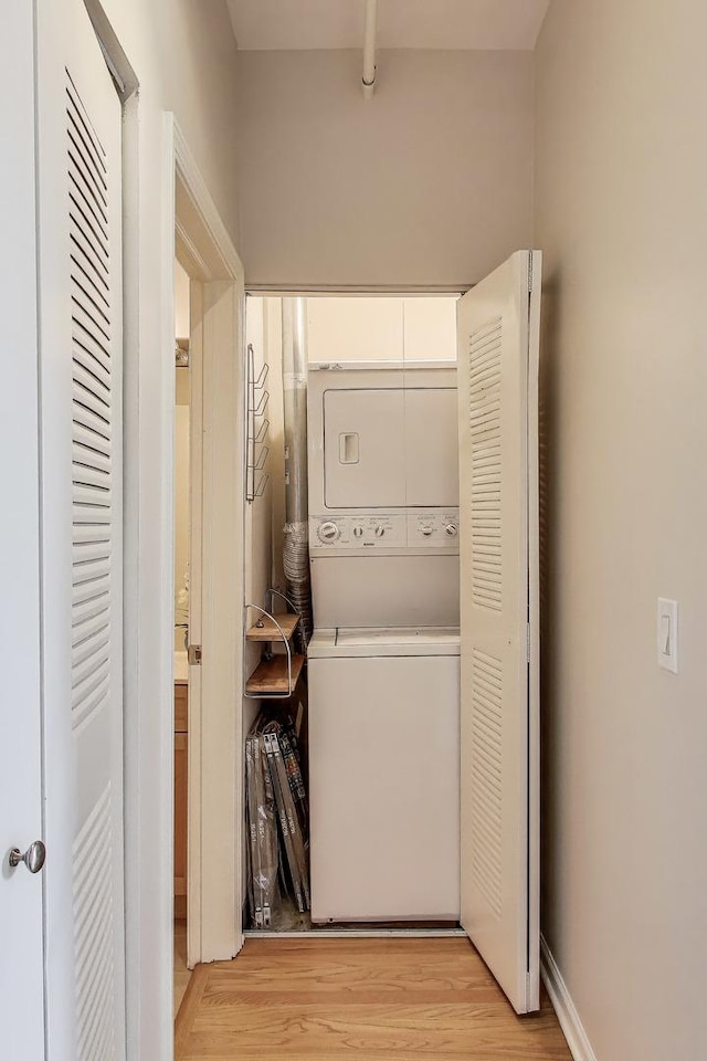 1735 W Diversey Pkwy Unit 206, Chicago, IL 60614 - washroom with stacked washing machine and dryer and light wood-style flooring