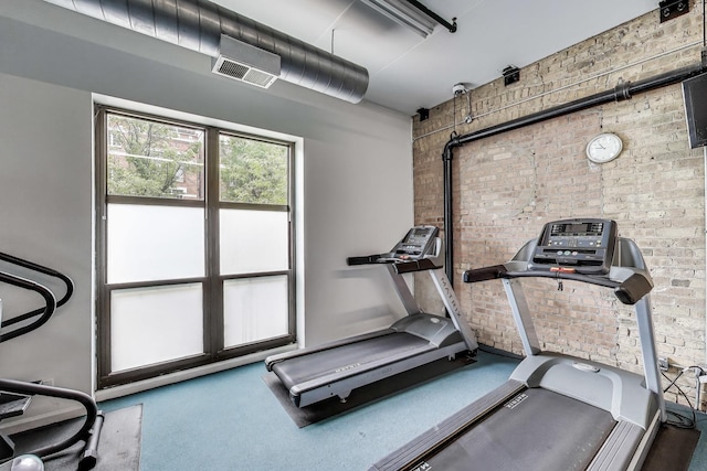 1735 W Diversey Pkwy Unit 206, Chicago, IL 60614 - exercise room featuring brick wall and carpet flooring