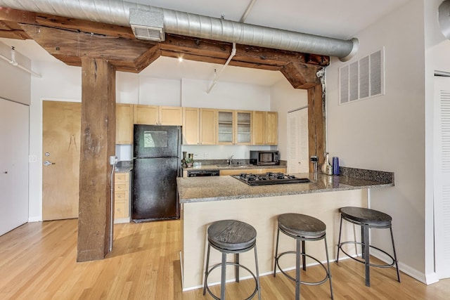1735 W Diversey Pkwy Unit 206, Chicago, IL 60614 - kitchen with black appliances, light wood-type flooring, glass insert cabinets, and a peninsula