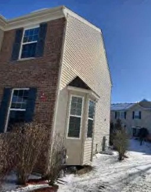 175 Owen St, Matteson, IL 60443 - view of snow covered exterior with brick siding