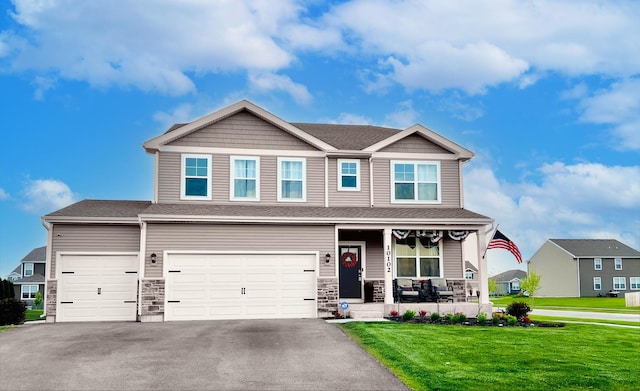 10102 Jonamac Ave, Huntley, IL 60142 - craftsman house with a porch, a front lawn, driveway, a garage, and stone siding