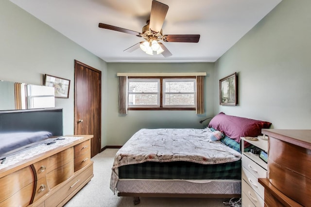 bedroom with baseboards, light carpet, and ceiling fan