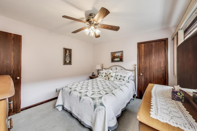 carpeted bedroom with baseboards and a ceiling fan
